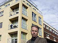 Cllr Paul Convery outside the flats threatened with demolition